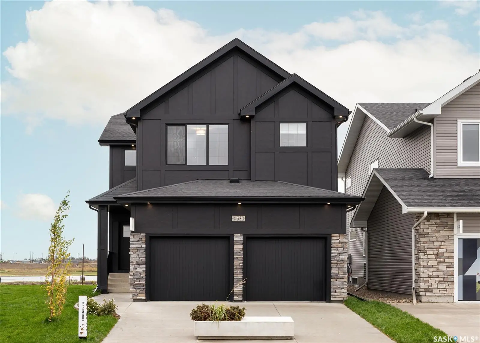 Exterior photo of 955 Traeger Manor, Saskatoon, SK showing a brand-new two-storey Starkenberg model home in Brighton.
